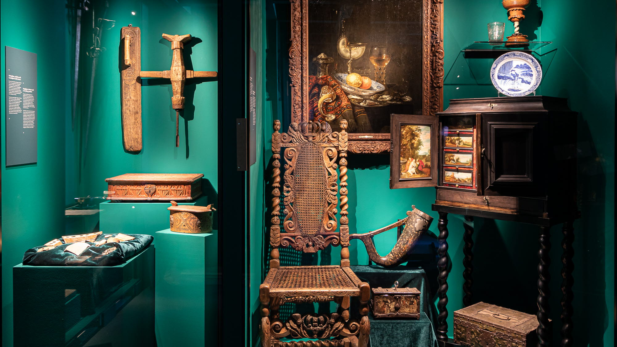 En monter med stol, tavla med mera i den kulturhistoriska utställningen Vägen hit.