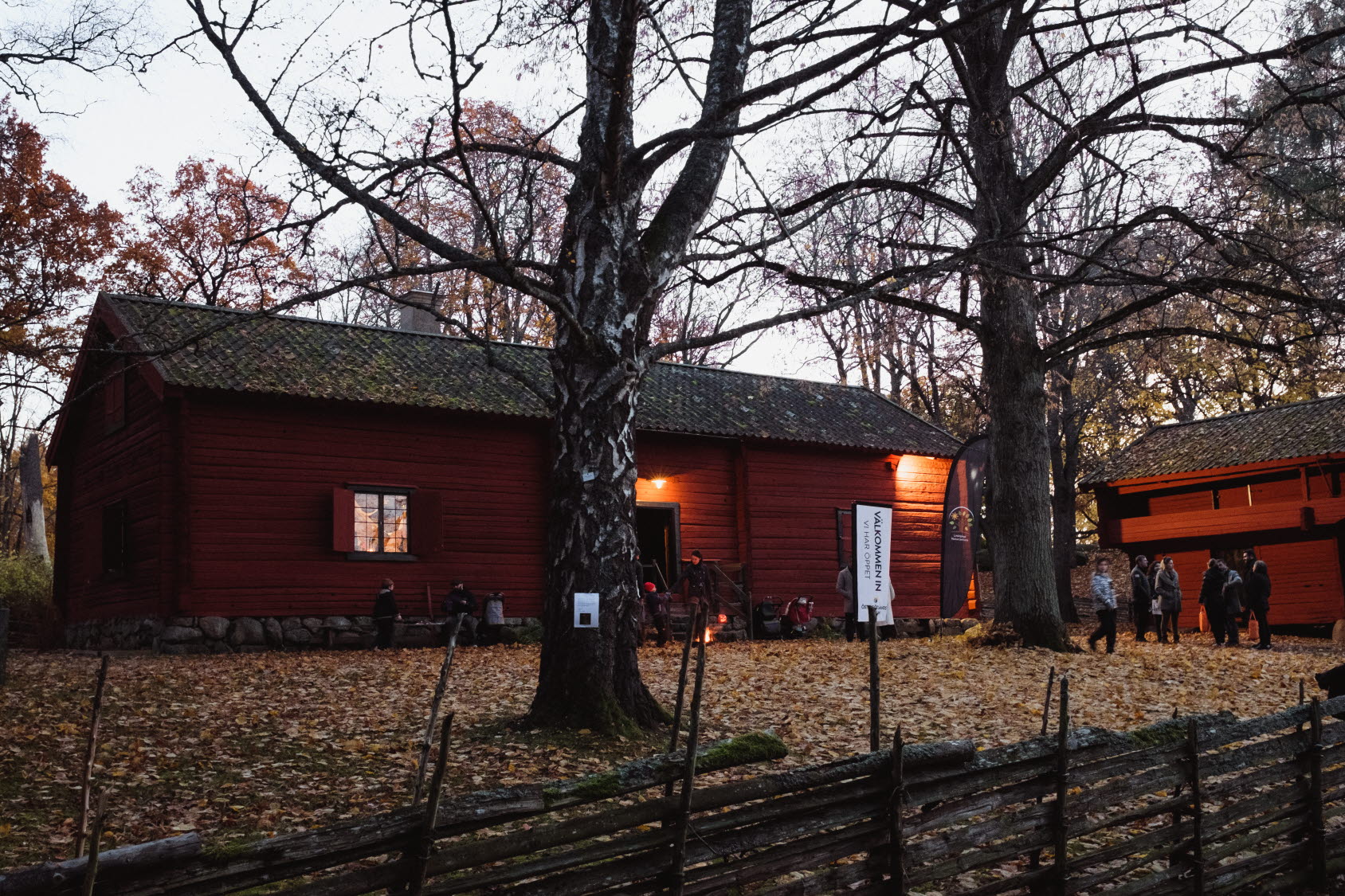 Människor utanför Krogsfallsgården i Trädgårdsföreningen en höstdag.
