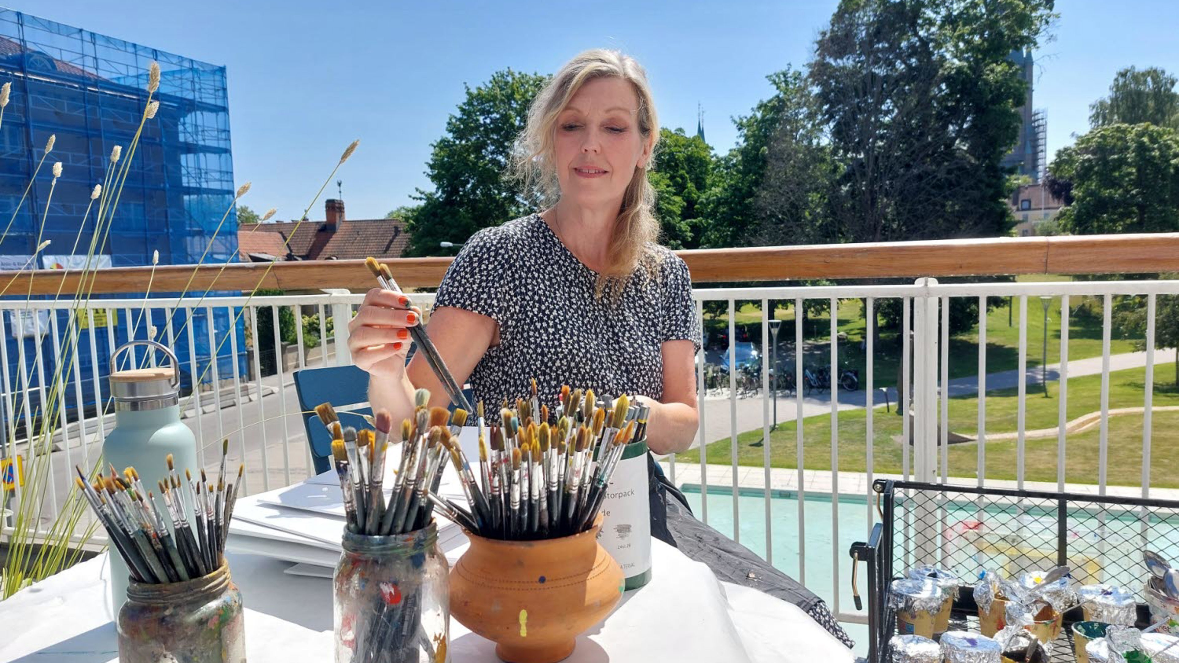 Konstpedagog Åsa Nyberg Botshinda håller i stafflimålning på Östergötlands museums takterrass.